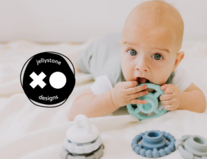 Baby playing with Jellystone Design teething stacker toy